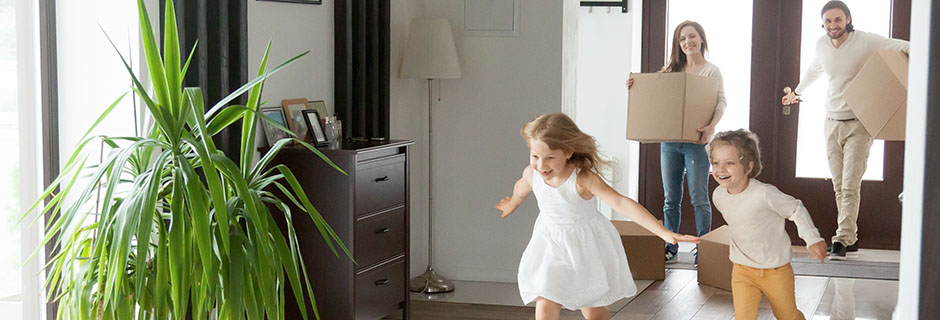 children-running-into-new-house-parents-with-boxes-on-background-mobile-desktop-940x320